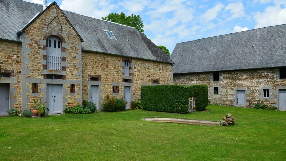 Ferme périgourdine avec grange et toiture en tuiles dans la campagne